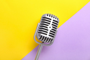 Fototapeta na wymiar Retro microphone on color background