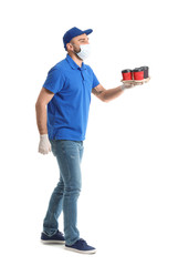 Male courier of food delivery service in medical mask on white background
