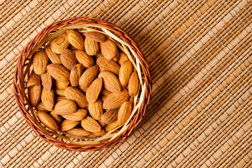 Almonds nuts shot large on a wooden background. Background for healthy eating and vegetarianism.