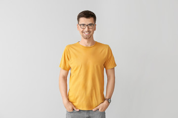 Man in stylish t-shirt on grey background