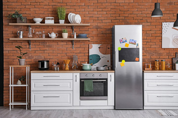 Stylish interior of modern kitchen with big refrigerator