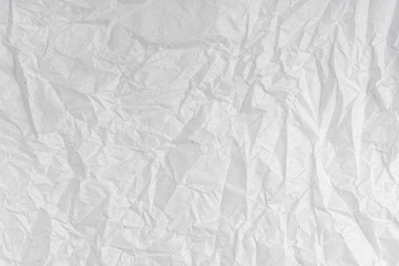 White wrinkled creased paper texture. Blank crumpled grainy paper textured surface.