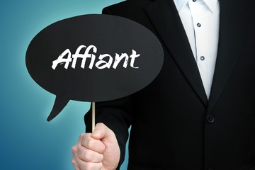Affiant. Lawyer in suit holds speech bubble at camera. The term Affiant is in the sign. Symbol for law, justice, judgement