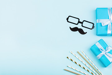 Happy Birthday or Fathers Day background with gifts and paper straws on table top view. Flat lay style, overhead, mockup, template, copy space. Horizontal banner.