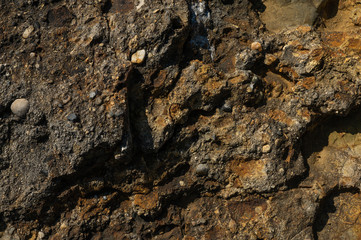 Textured stone texture with hard light, for design. Orange rock.