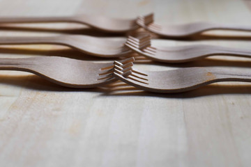Wooden forks laid on a wooden texture background