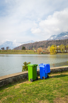 Trash bins dustbins for waste collection and segregation kept at the side of a lake in Kashmir