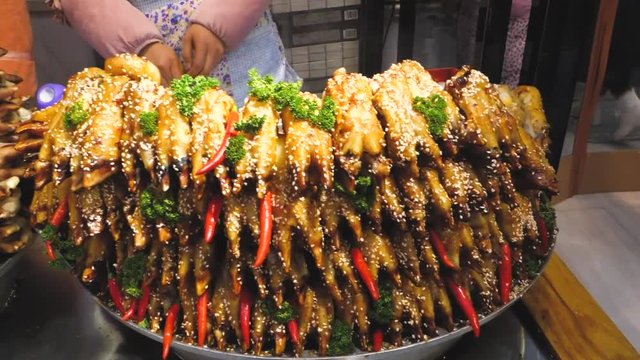 China market, stacks of cow hooves with chilis and sesame seeds being sold