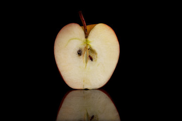 Half a juicy apple on a black background with reflection. Close-up. Healthy lifestyle and vegetarianism.