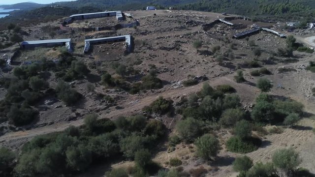 Drone flight above abandoned military barracks in the mountains of greece.
