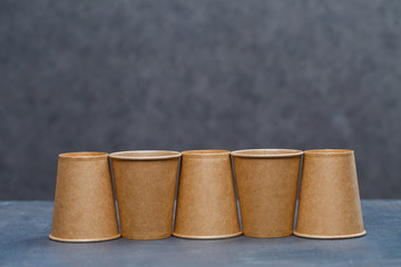 Paper cups for drinking, dishes. Disposable cardboard dishes made from environmentally friendly materials. Doesn't clog nature Eco-friendly, disposable, reusable, compostable dishes.