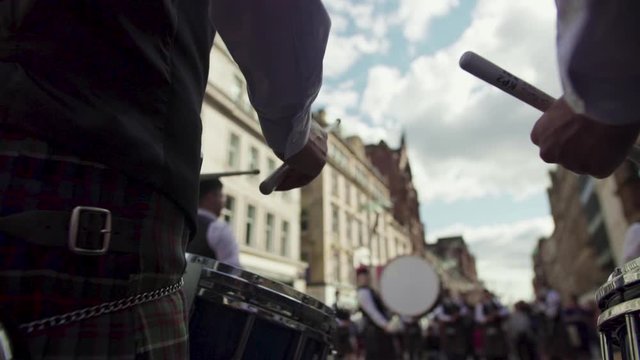 Close up of scottish band member playing drums in the streets of Glasgow.