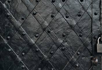 Old black metal door of Boim Chapel in Lviv. Vintage background close-up.