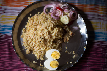 Homemade chicken Biryani is being served in a steel plate. Indian homemade food