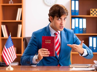 Young handsome politician sitting in office