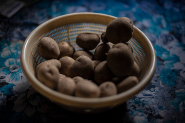 A basket full of potato kept in the Indian kitchen during the lock down period.