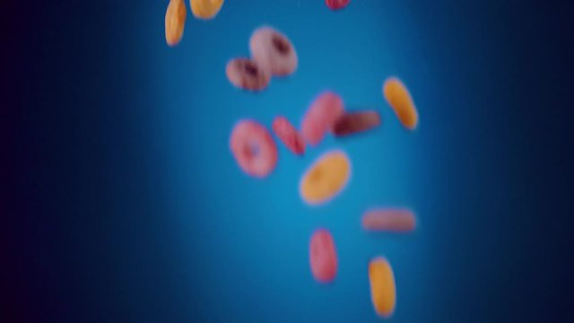 Breakfast Cereals Fruity Loops Falling in Slo- Motion with blue background