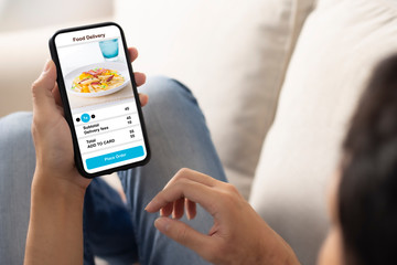 holding phone with application delivery food online