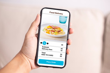 holding phone with application delivery food online