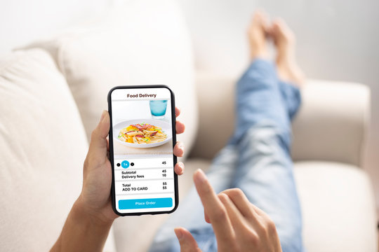 holding phone with application delivery food online