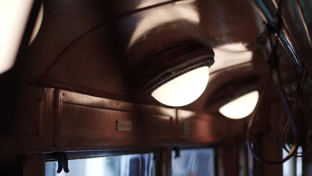 Inside a dimly lit vintage tram