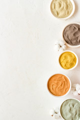 cosmetic clay - Yellow, red, white, blue and black dry powder - top-down flat lay space for text