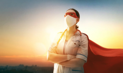 Doctor wearing facemask and superhero cape