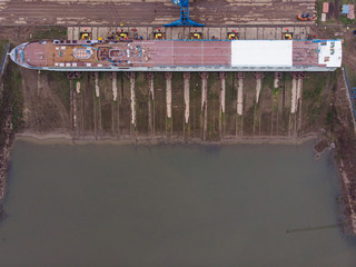 Aerial view of shipyard building a ship and getting ready for water.