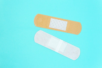 skin color medicine adhesive healing bandage layout on blue background. medical aid healing patch concept
