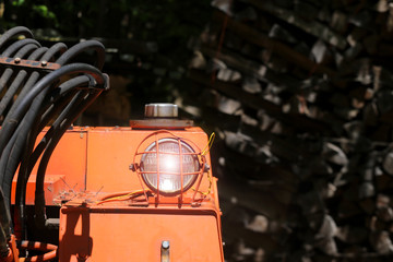 Bulldozer headlight, huge orange powerful construction machine