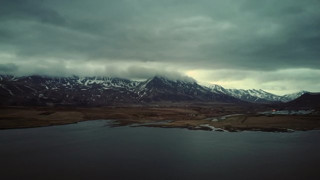 Aerial view of Esjan mountain in Iceland on a cloudy day. Track forward.