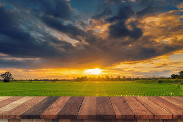 Rice field sunset and Empty wood table for product display and montage.