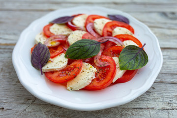 Delicious Italian caprese salad with tomatoes and mozzarella.