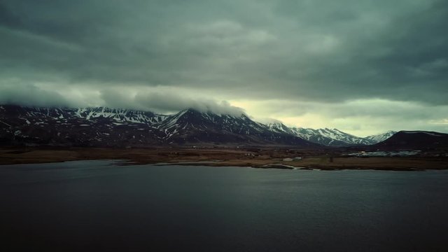 Aerial view of Esjan mountain in Iceland on a cloudy day. Boom down.