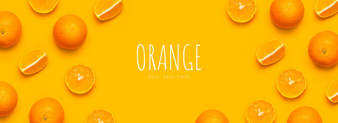Fresh juicy whole and sliced orange on bright yellow background. Fruit pattern, creative summer concept. Flat lay Top view. Minimalistic background with citrus fruits, vitamin C. Pop art design Banner