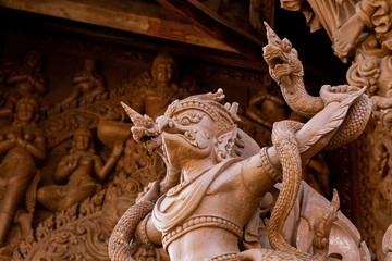 wooden garuda and naga on temple in Thailand .