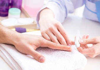Obraz na płótnie Canvas Hands during manicure care session