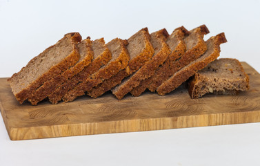 Rye homemade bread on wooden cutting Board on white background