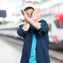 Young man wearing a blue outfit. Looking scared.