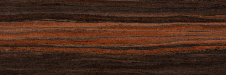 Unique ebony veneer background in brown color. Natural wood texture, pattern of a long veneer sheet, plank.