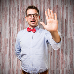 Man wearing a red bow tie. Showing his palm.