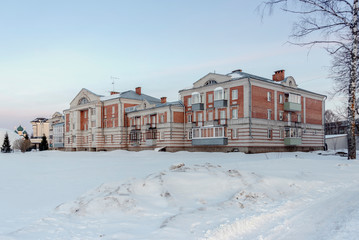 Modern apartment building in a small town in the snow in winter