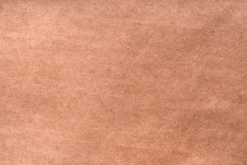 Textured craft surface. Brown paper sheet texture background or cardboard surface