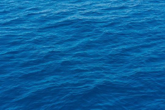 A close up of the deep and pristine blue Mediterranean sea on a sunny day, in Sardinia Italy © Davide