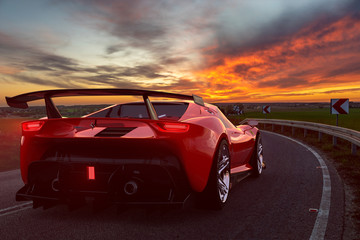 Ferrari sports car on a winding road at sunset