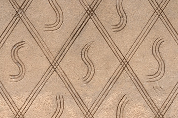 Concrete wall texture with ornament. Stone surface background. Abstract ornament pattern and cement texture, vintage background.