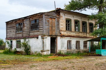 An old abandoned brick two-storey building in a russian village