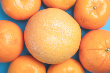 Fresh whole grapefruits on a blue background.