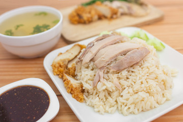 Chicken rice on the table, brown wood background.