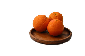 Oranges on a wooden plate